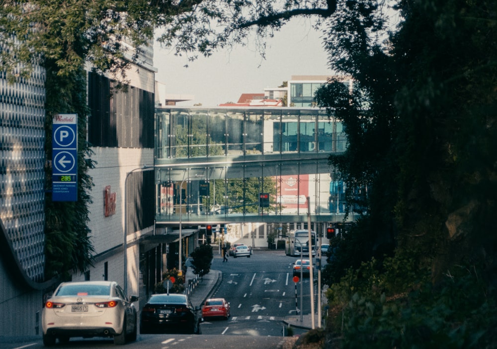 a city street filled with lots of traffic next to tall buildings