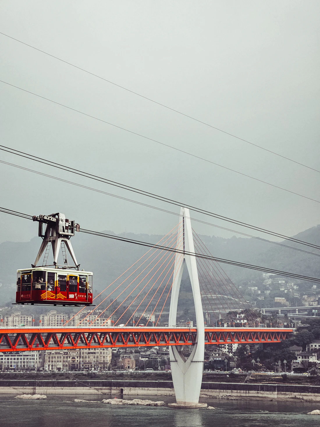 The red Yangtze River Cableway gondola crossing the river in Chongqing