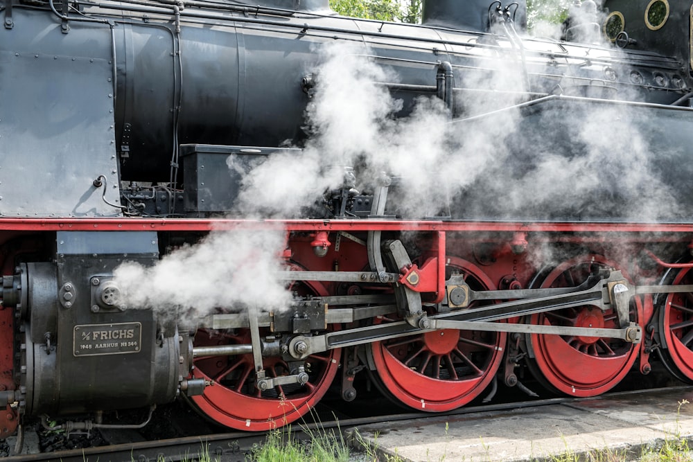 a steam engine train traveling down train tracks