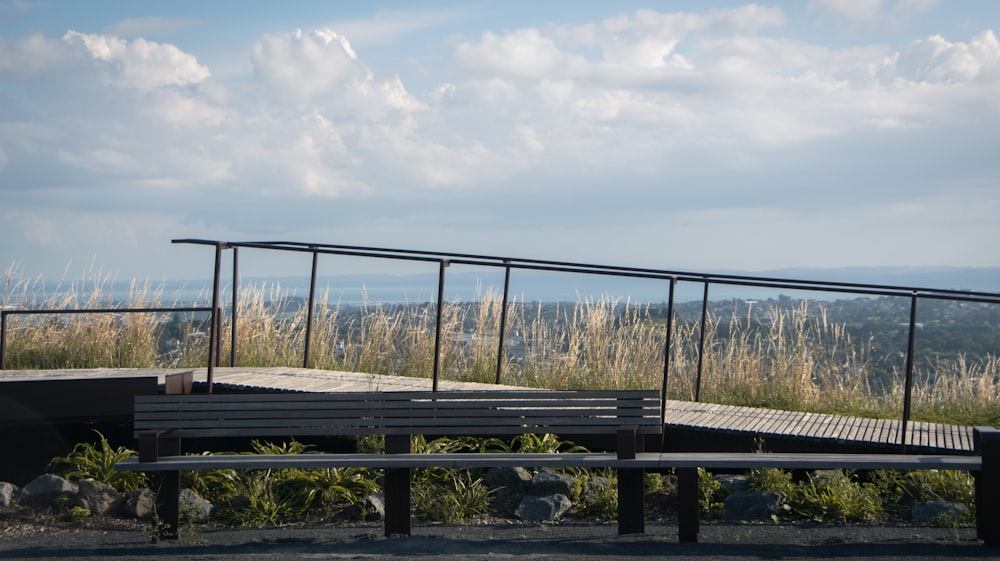 a bench on top of a hill overlooking a city