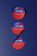 two stickers with the words i vote on them