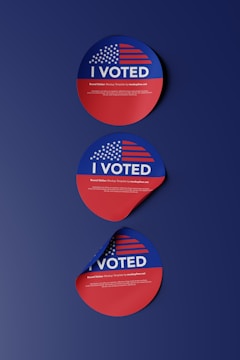 two stickers with the words i vote on them