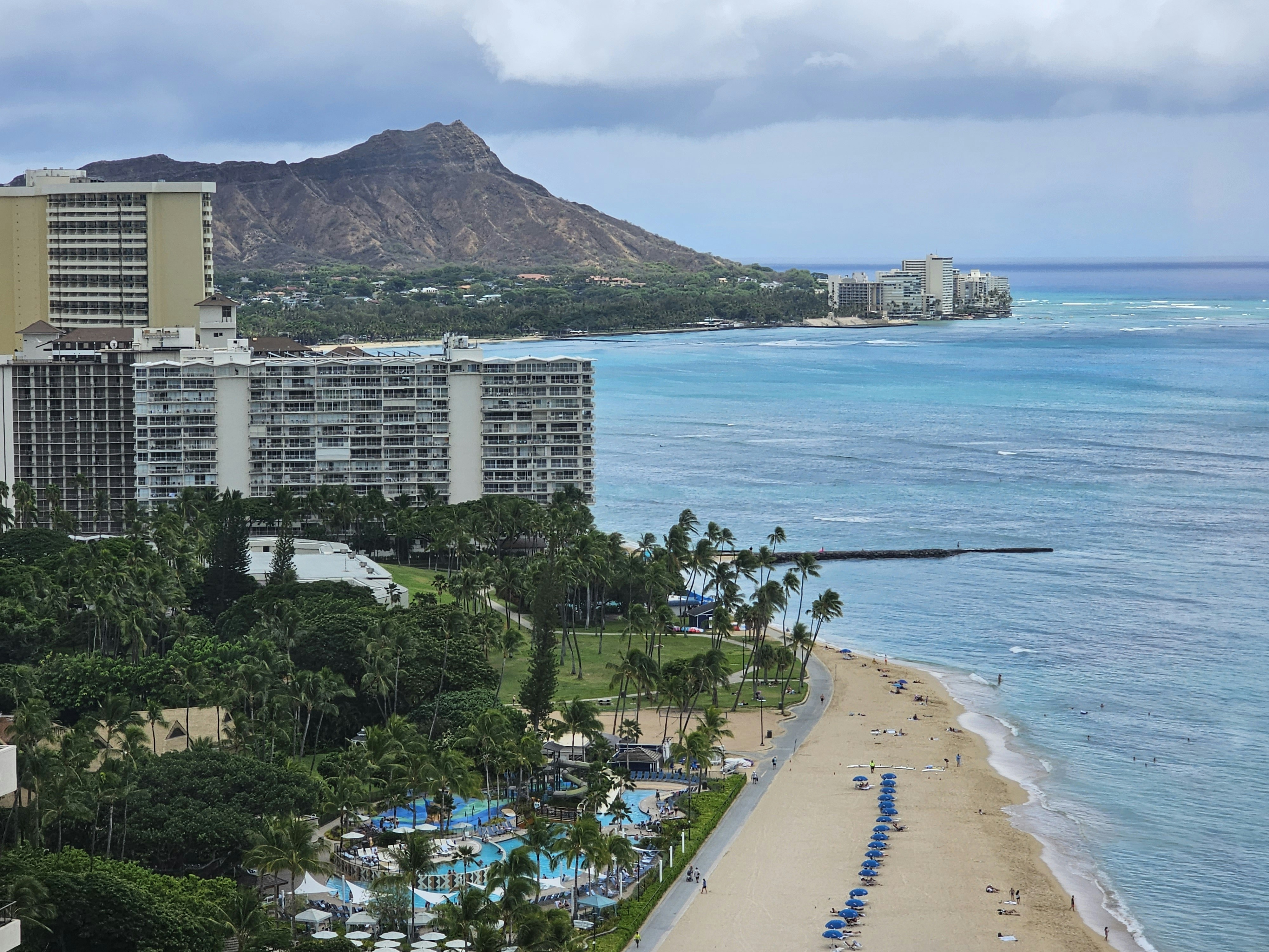 an aerial view of a beach and hotels near the ocean