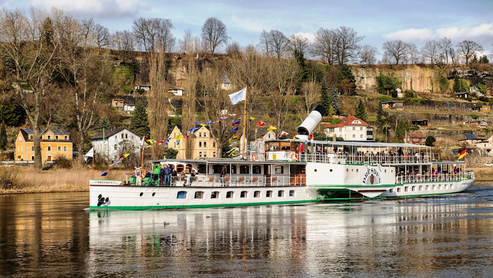 a large white boat floating on top of a river