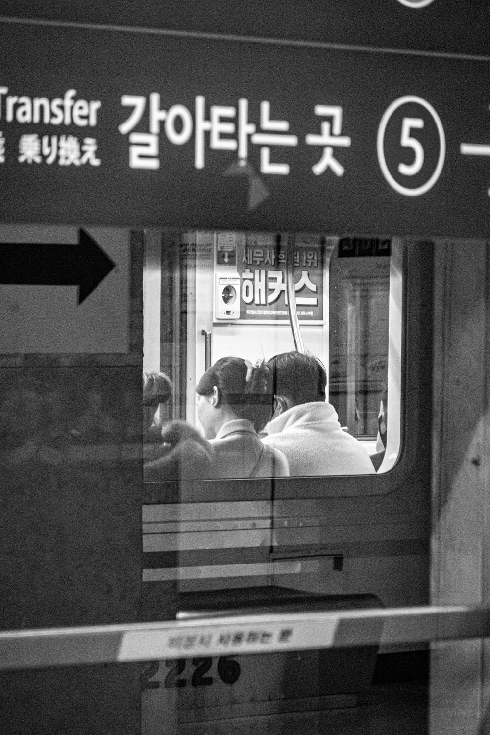 a black and white photo of people on a train