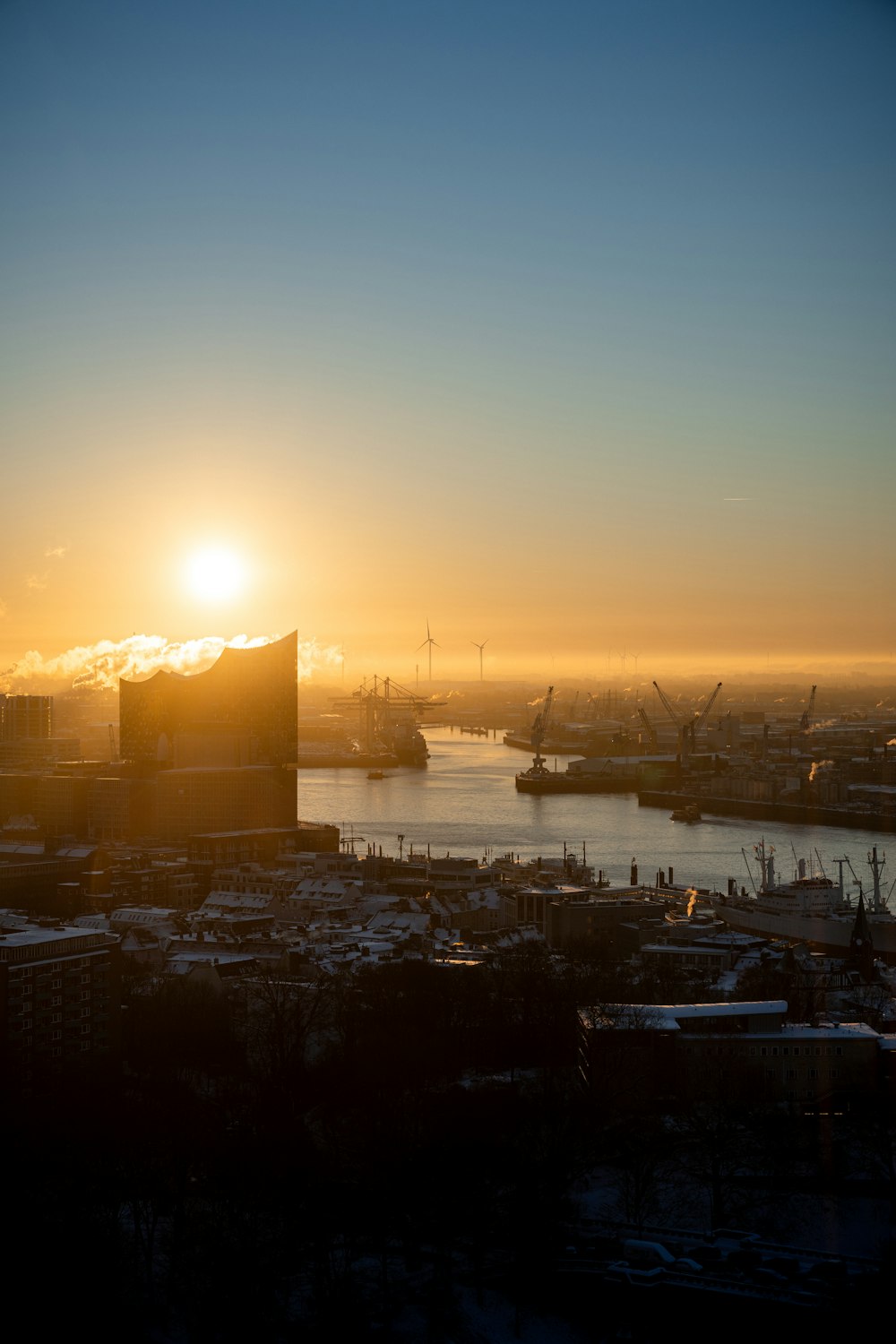 the sun is setting over a large city