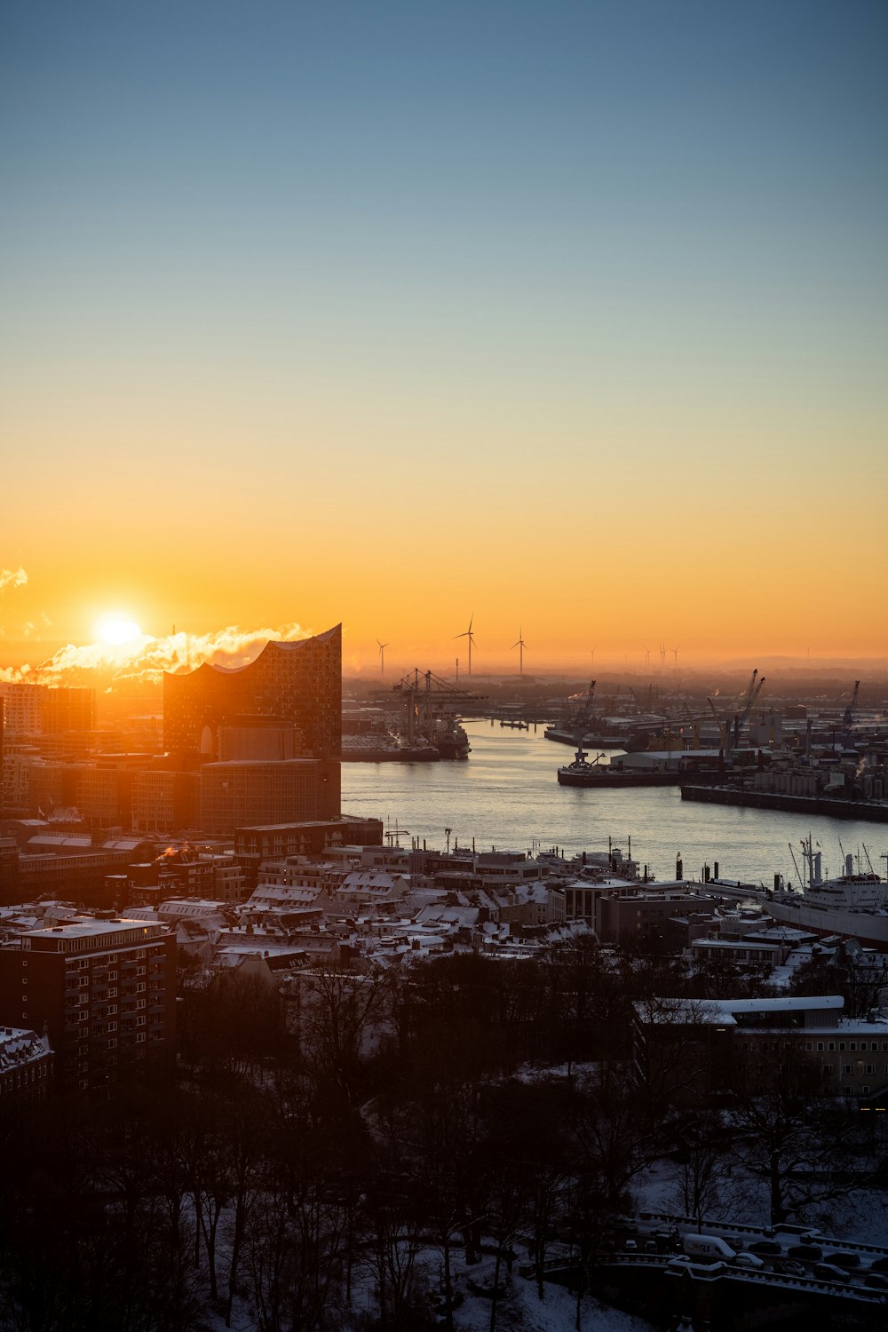 the sun is setting over a large city