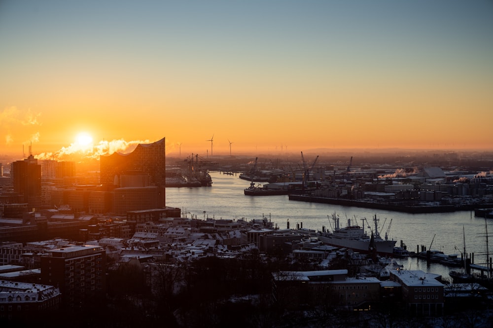 the sun is setting over a large city