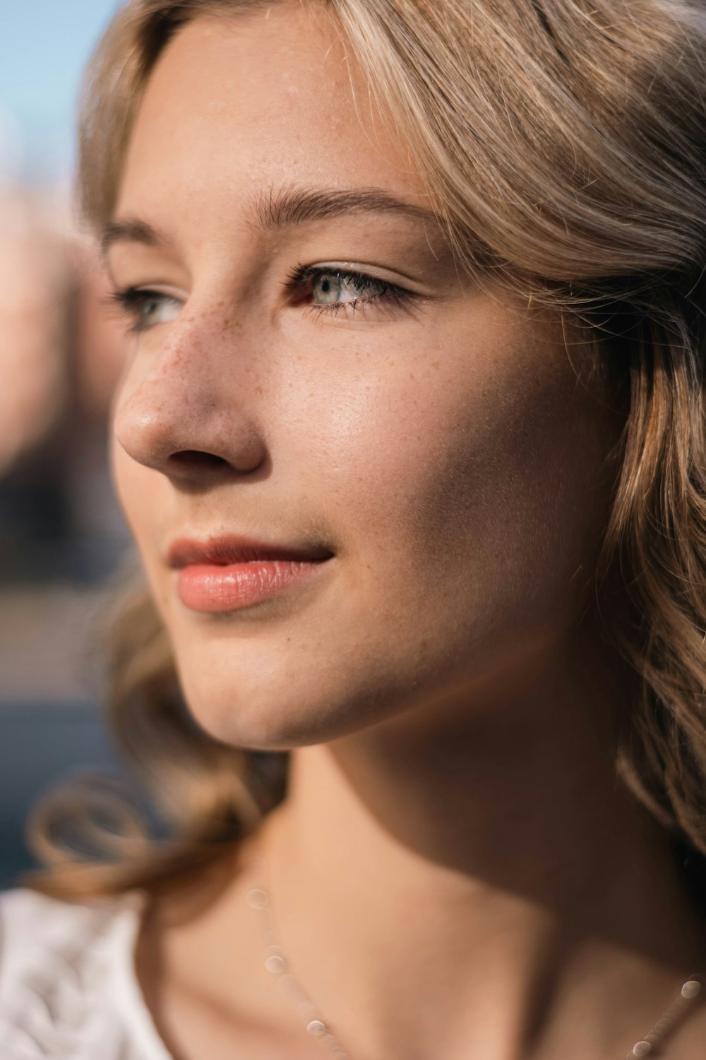 a close up of a person wearing a necklace