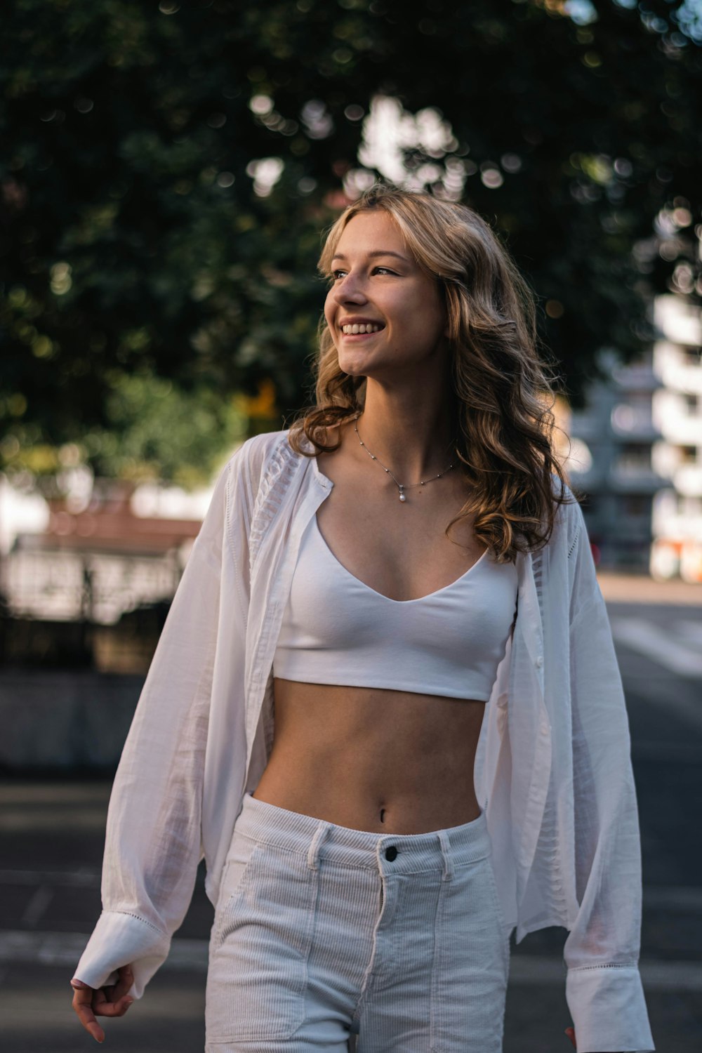 a woman walking down the street in a crop top