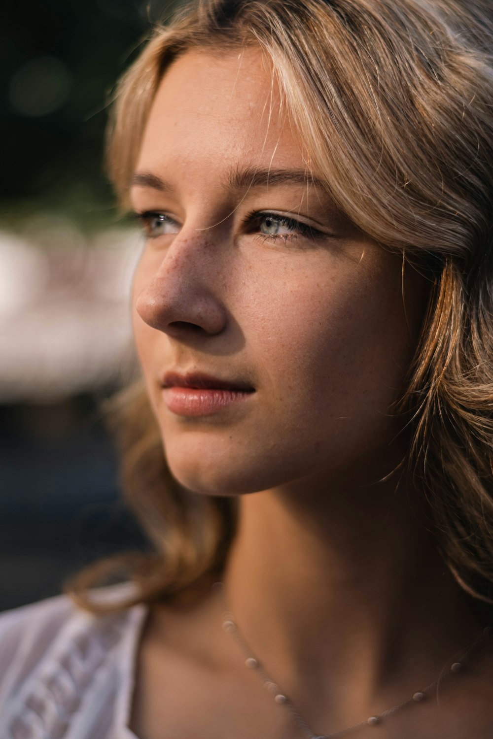 a close up of a person wearing a necklace