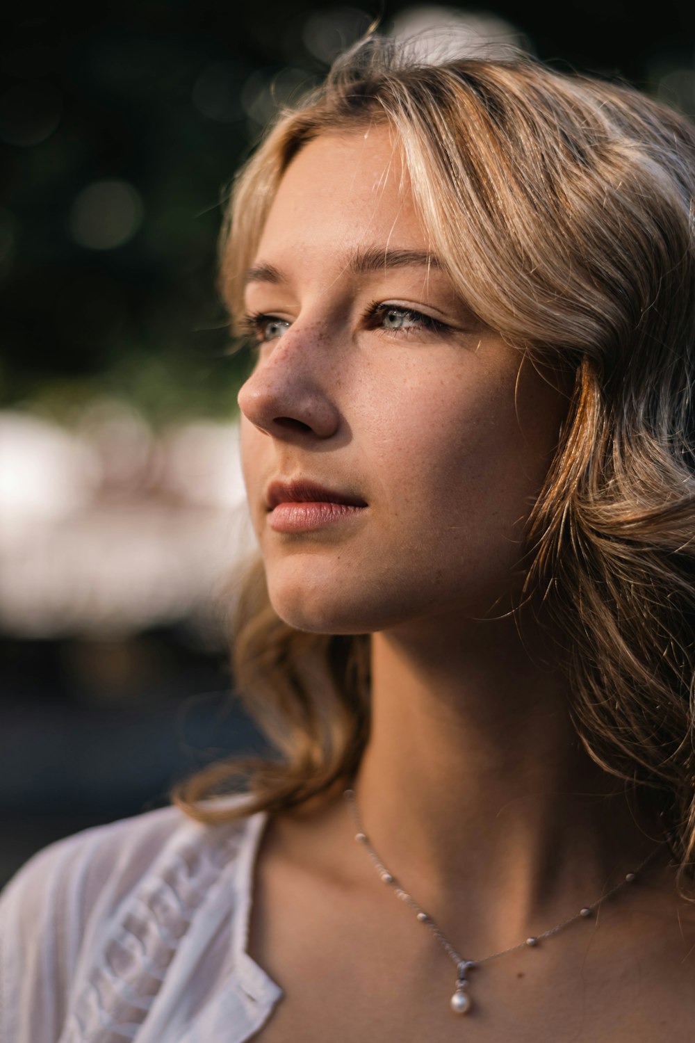 a close up of a person wearing a necklace