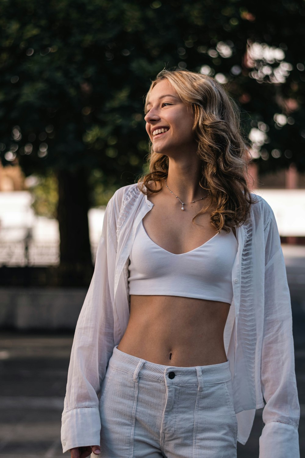 a woman in a white top and white pants