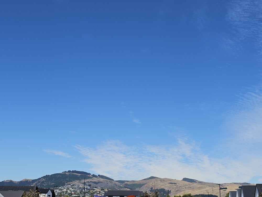 a view of a town with mountains in the background