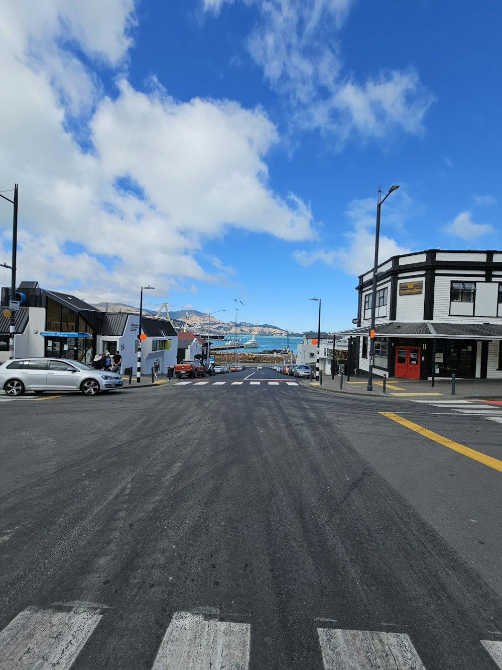 a city street with cars parked on the side of the road