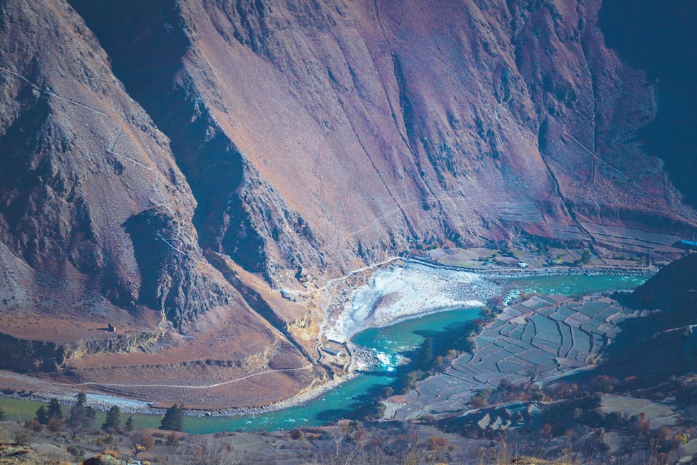 a river running through a valley surrounded by mountains