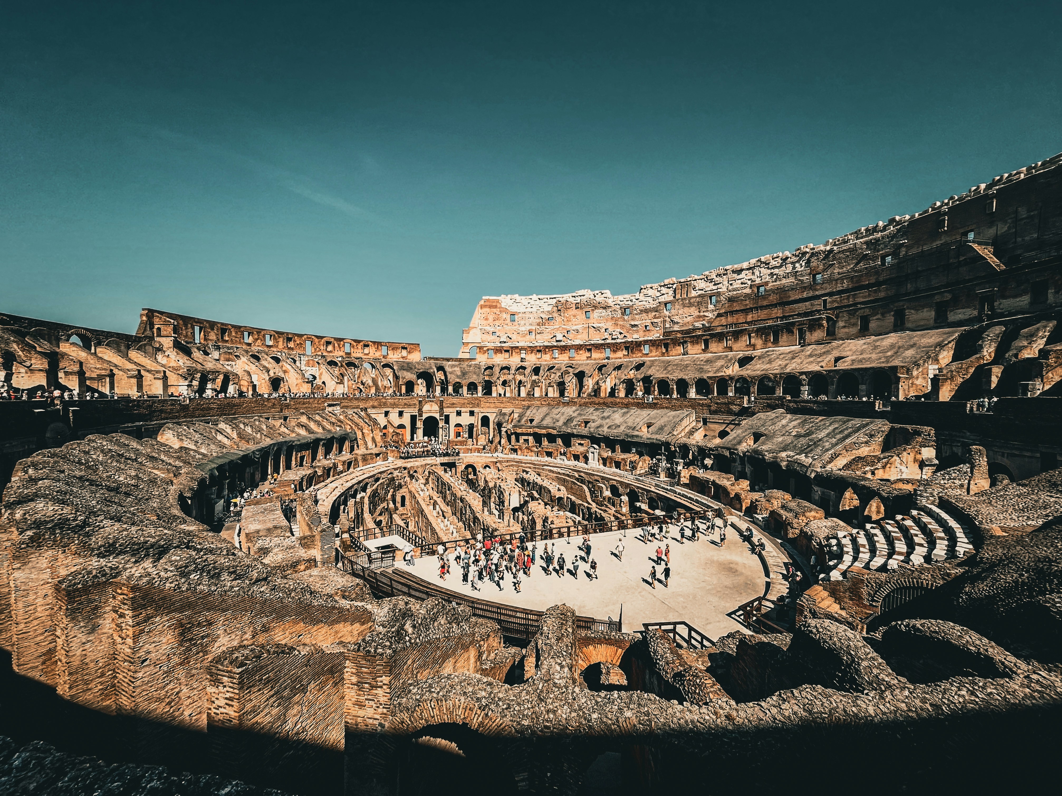 a group of people standing around a stone building