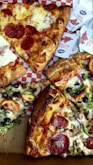 four slices of pepperoni pizza with various toppings