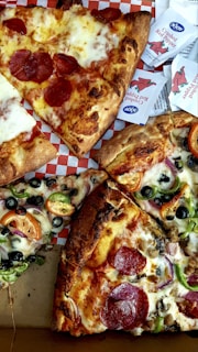 four slices of pepperoni pizza with various toppings