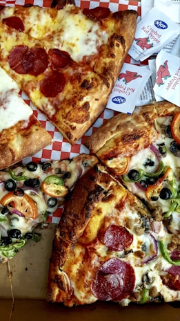 four slices of pepperoni pizza with various toppings
