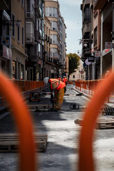 a construction worker is working on a street