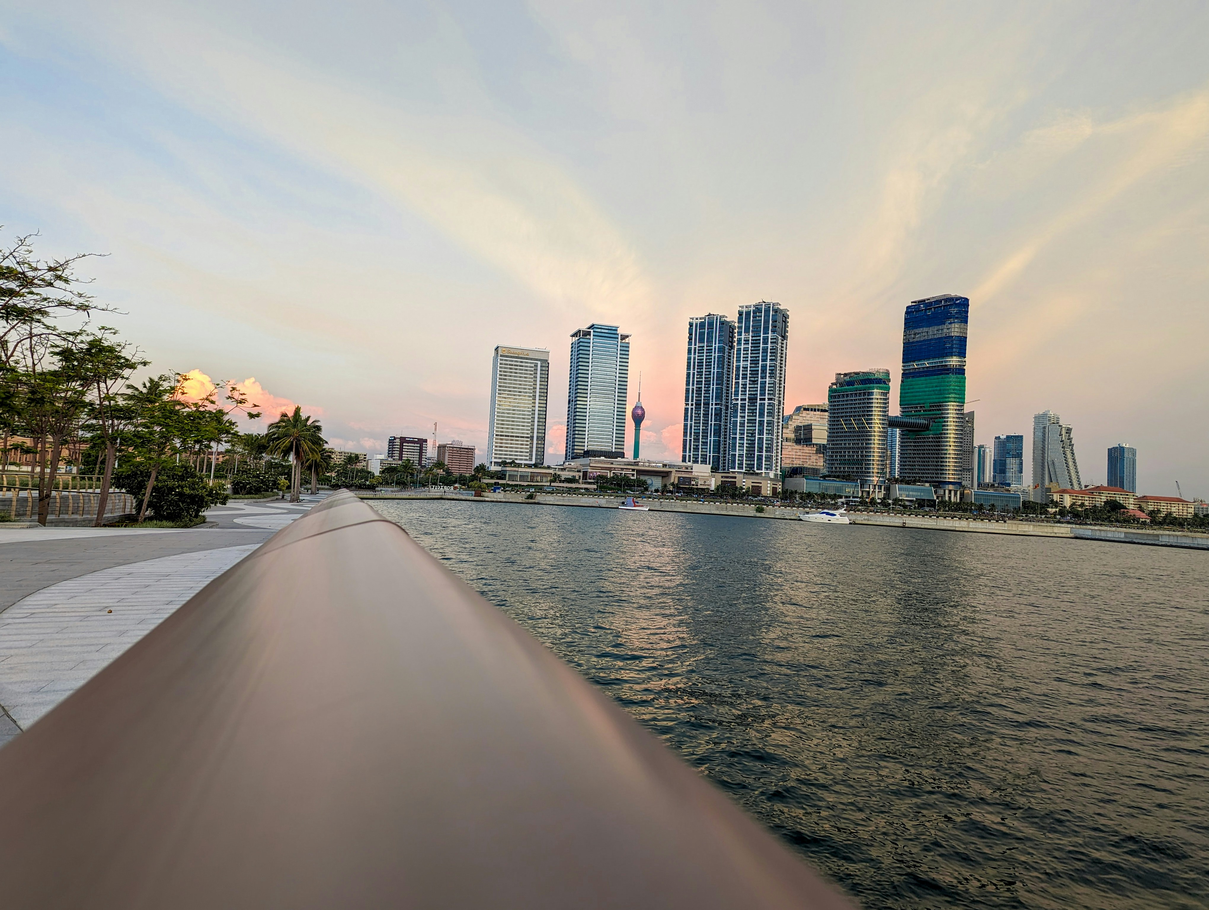 a boat traveling down a river next to tall buildings