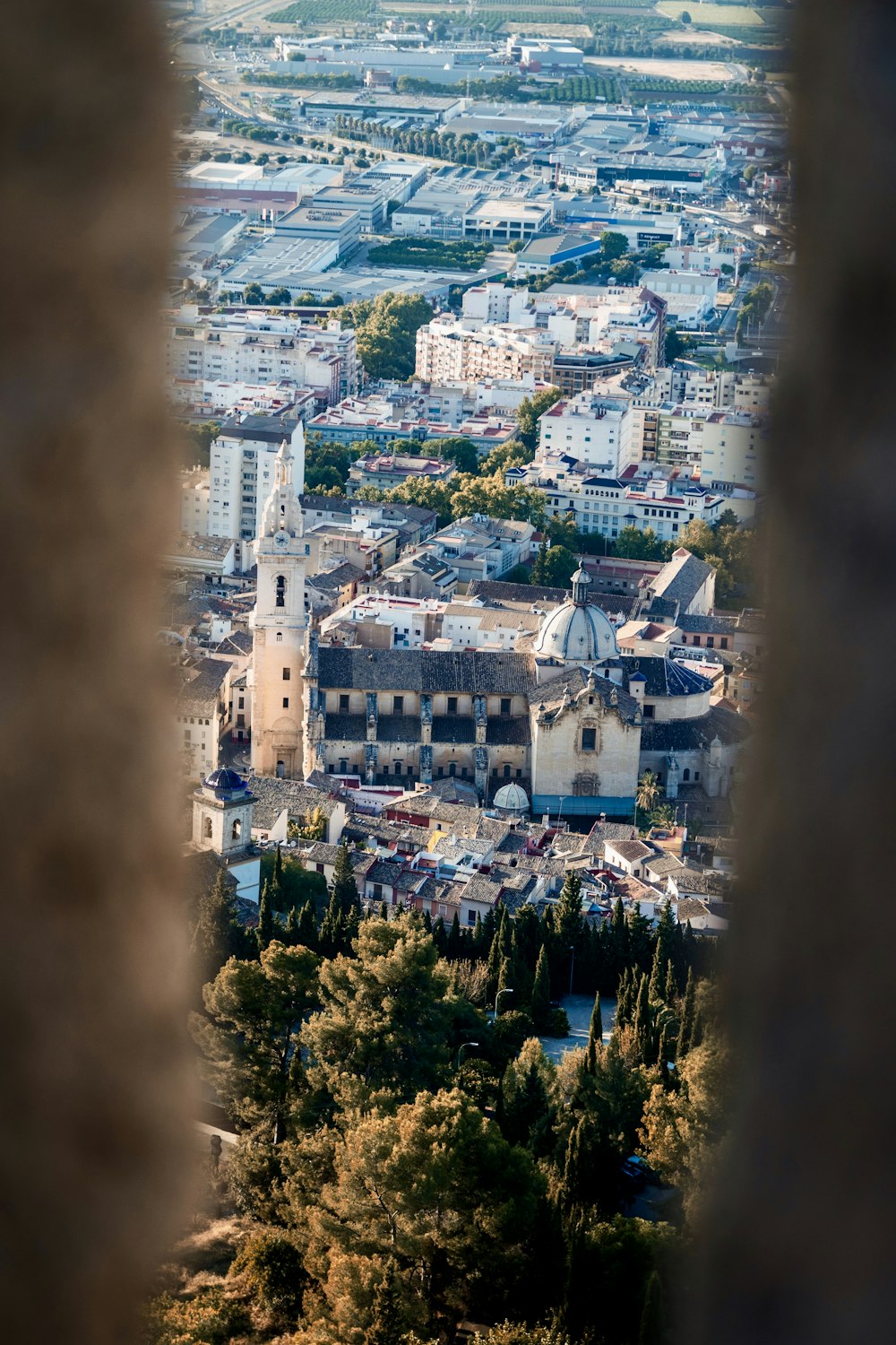 a view of a city through a hole in a wall