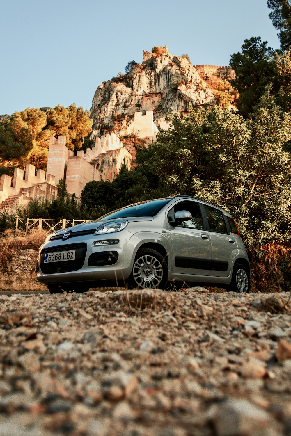 a small car parked in front of a mountain