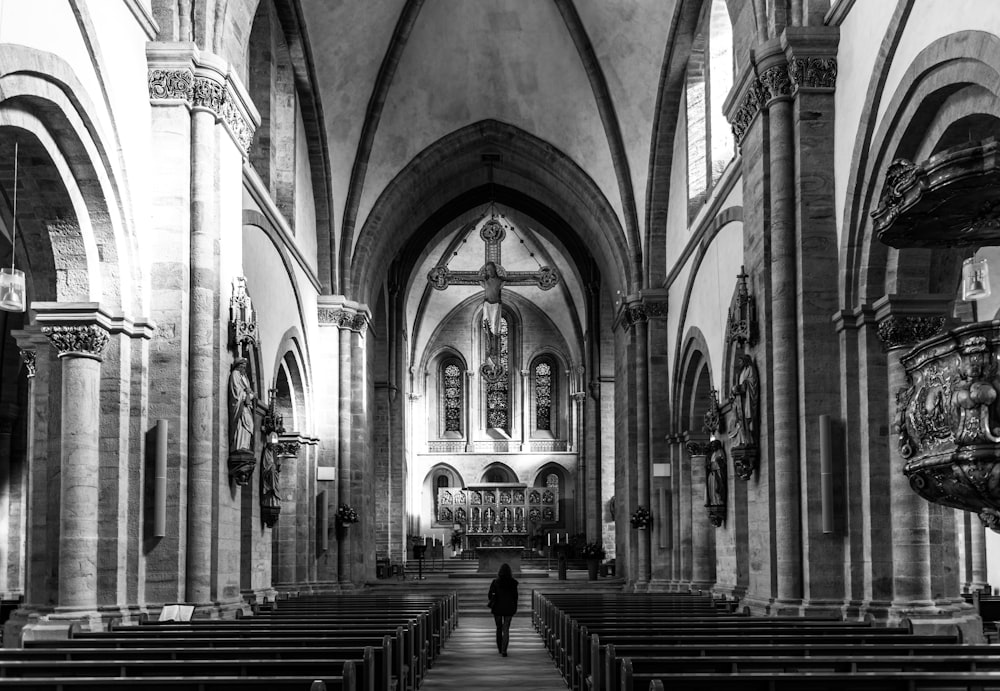 a black and white photo of a church with pews