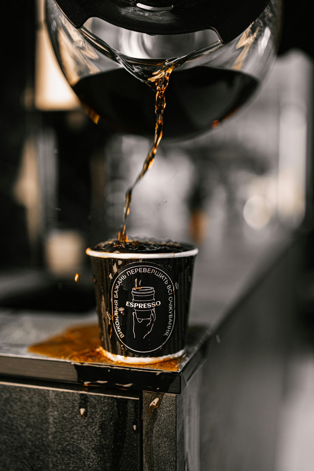 a cup of coffee being poured into a cup