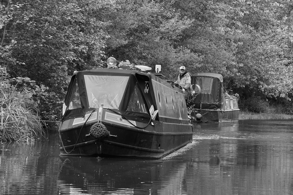 a couple of people riding on the back of a boat