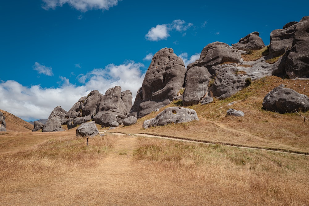 a person walking on a path between two large rocks