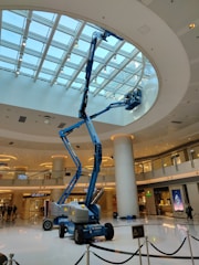 a man on a scissor in a large building