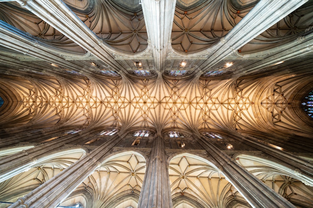 the ceiling of a cathedral with stained glass windows