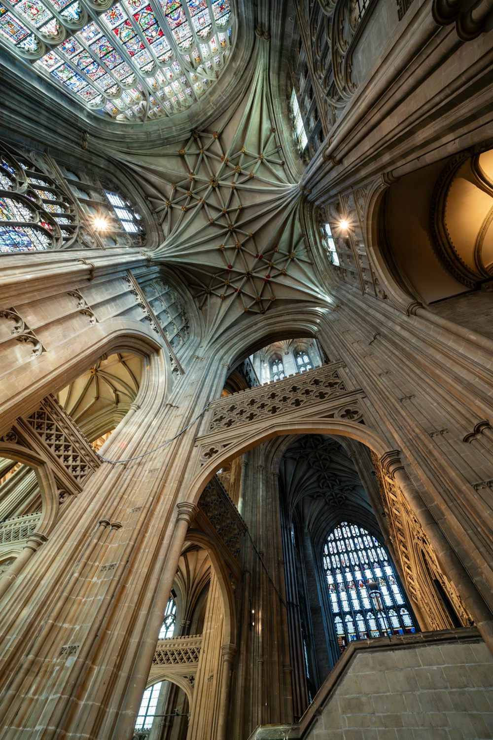 the ceiling of a cathedral with stained glass windows