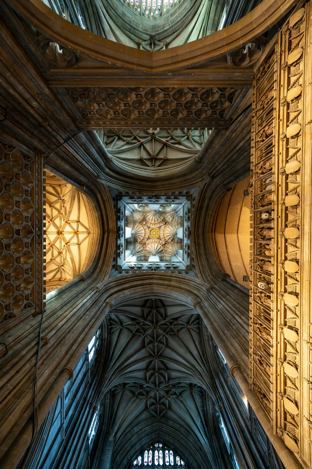 the ceiling of a cathedral with intricate carvings