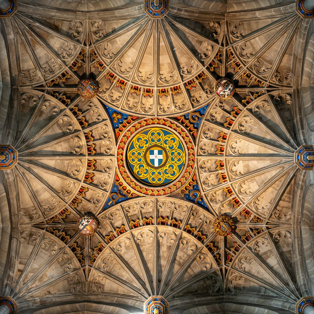 the ceiling of a cathedral with a cross in the center