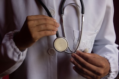 a person in a white shirt holding a stethoscope