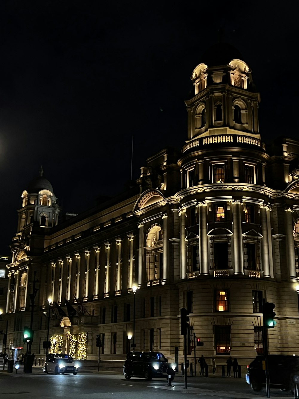 a large building with a clock tower at night