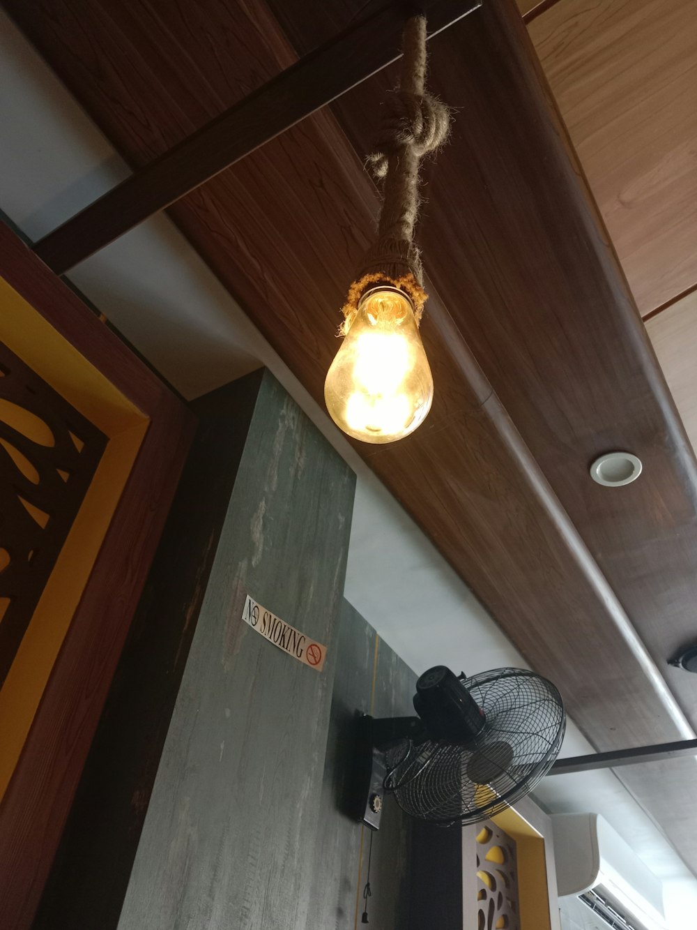 a light hanging from a ceiling in a room