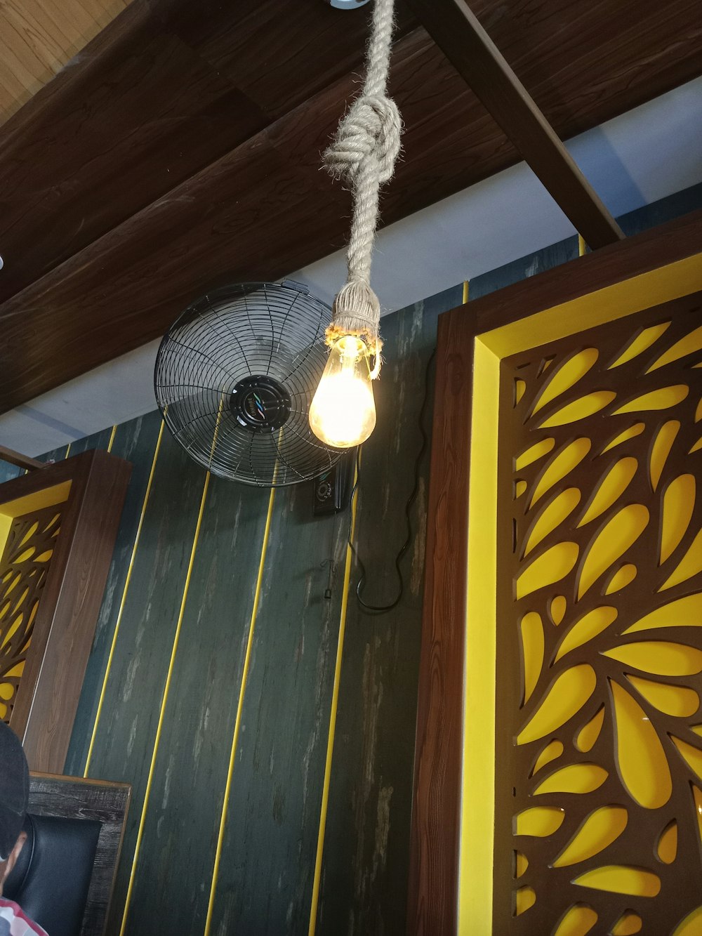 a ceiling fan hanging from the ceiling of a restaurant
