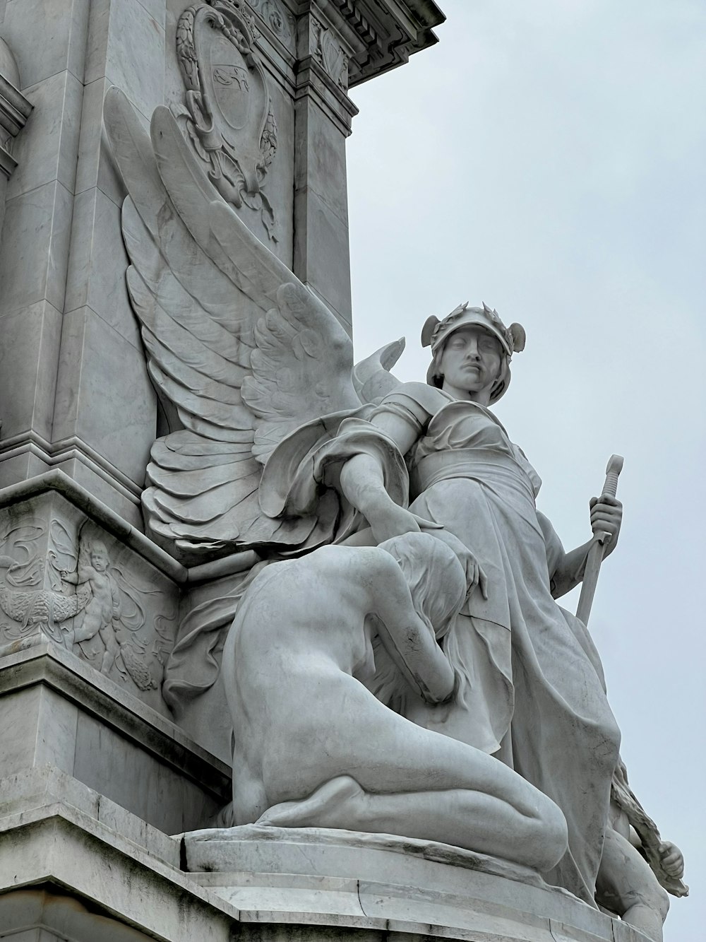 a statue of an angel holding a staff