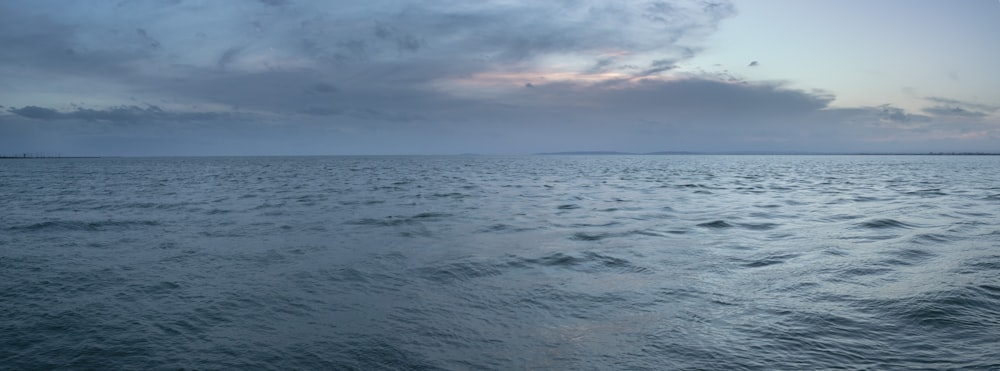 a large body of water under a cloudy sky