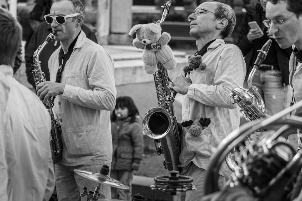 a group of men standing next to each other holding musical instruments