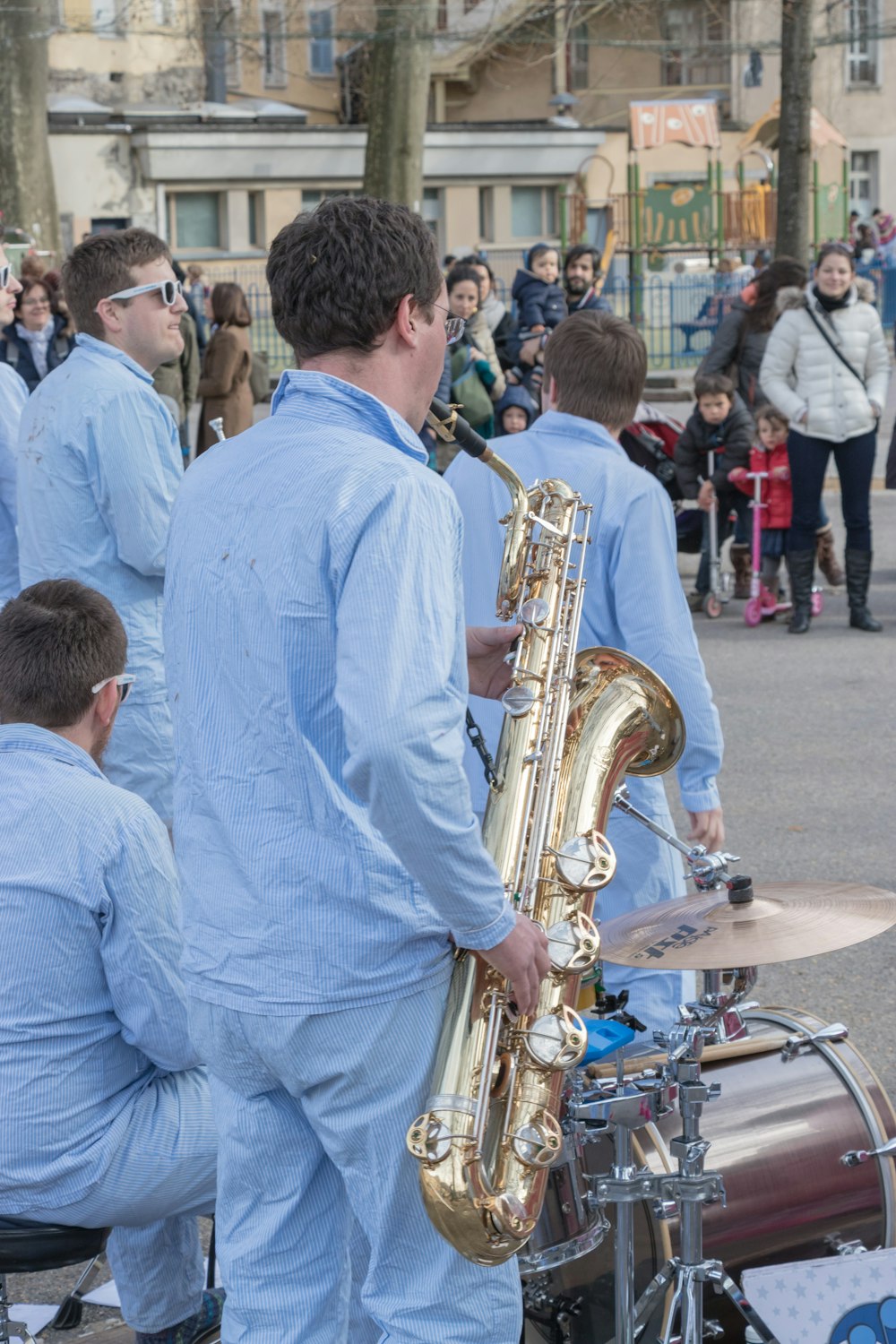 a group of men playing musical instruments in front of a crowd
