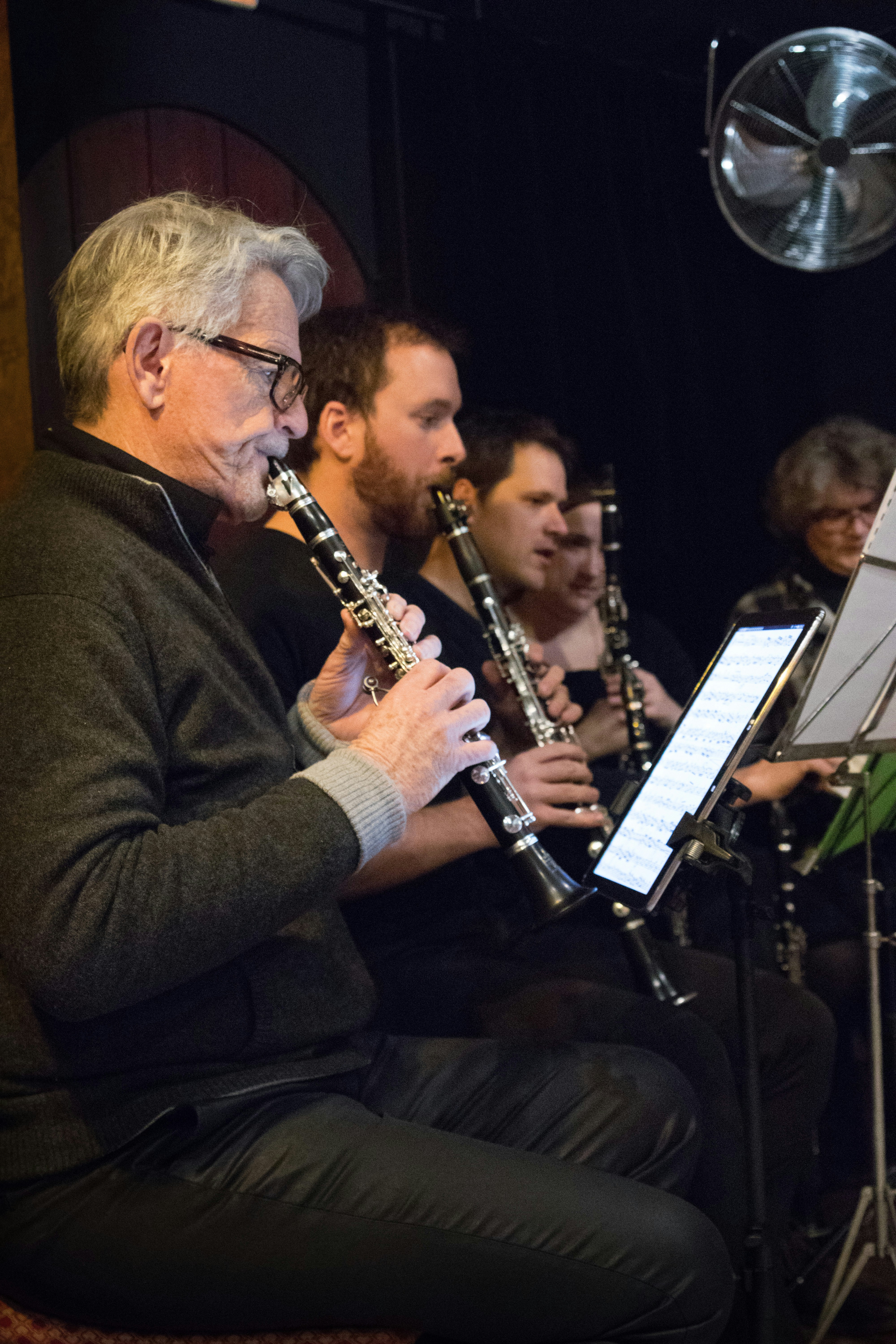 a group of people playing musical instruments in a room