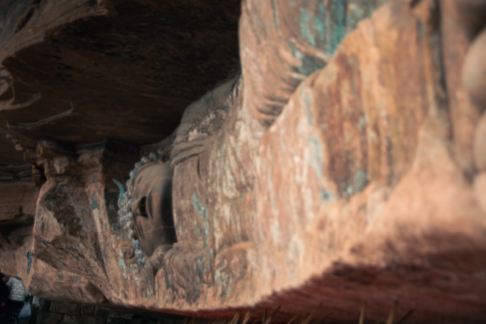 a person standing in front of a rock formation