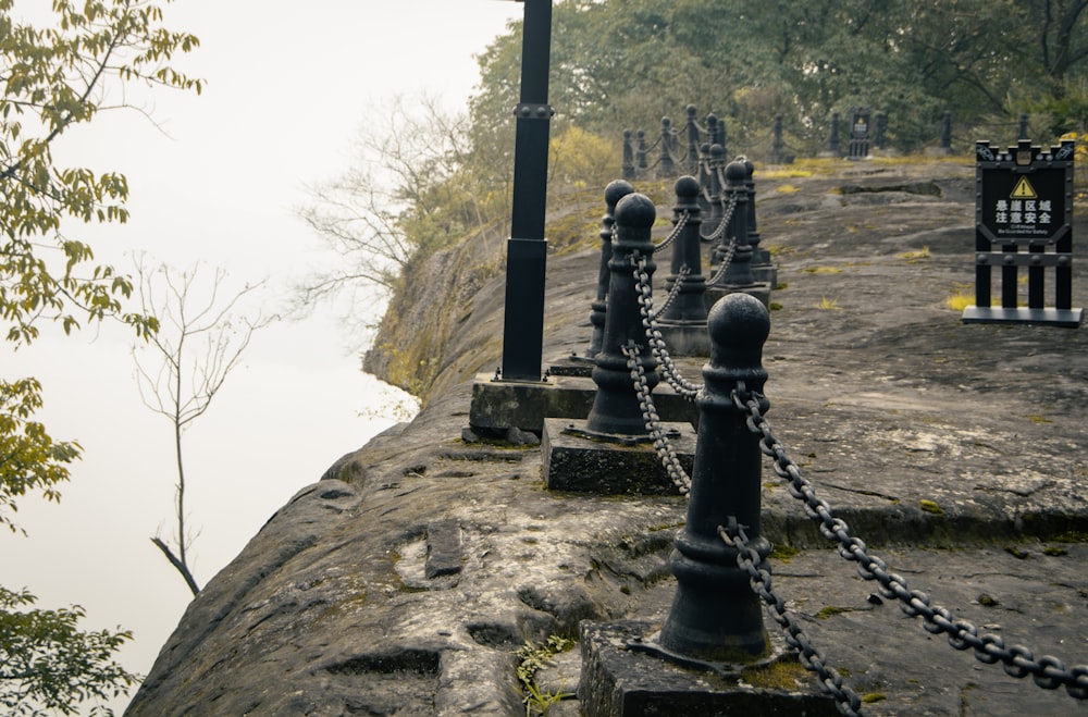 a chain link fence on the edge of a cliff