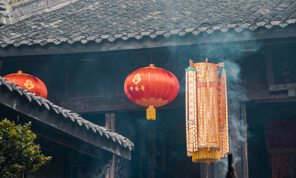 a couple of red lanterns hanging from a building