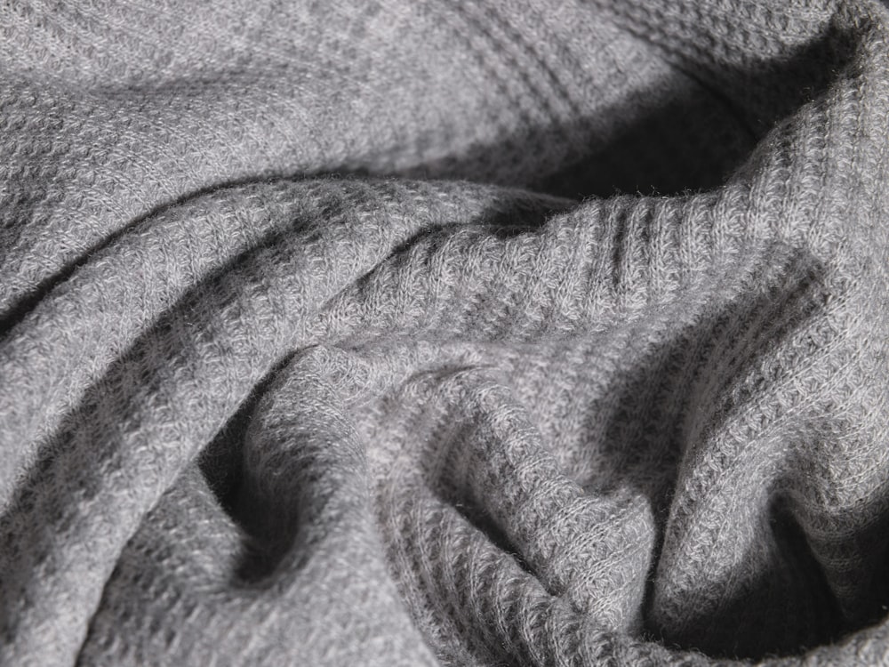 a close up view of a gray blanket